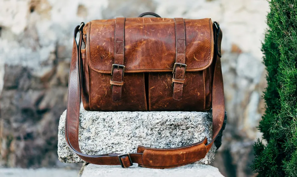 Brown leather messenger bag with buckled flap