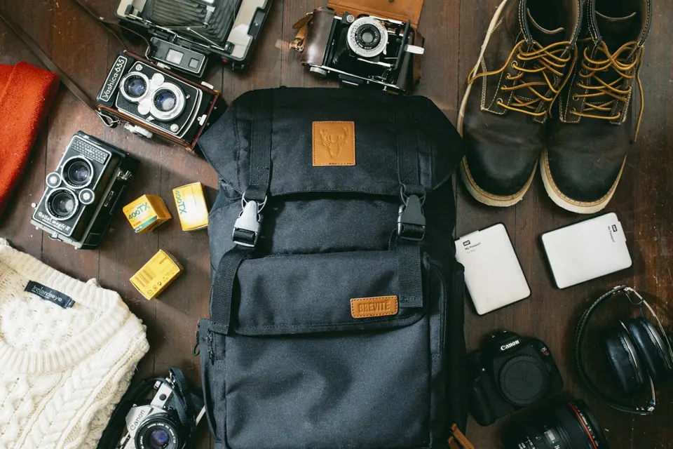 Black camera bag beside cameras