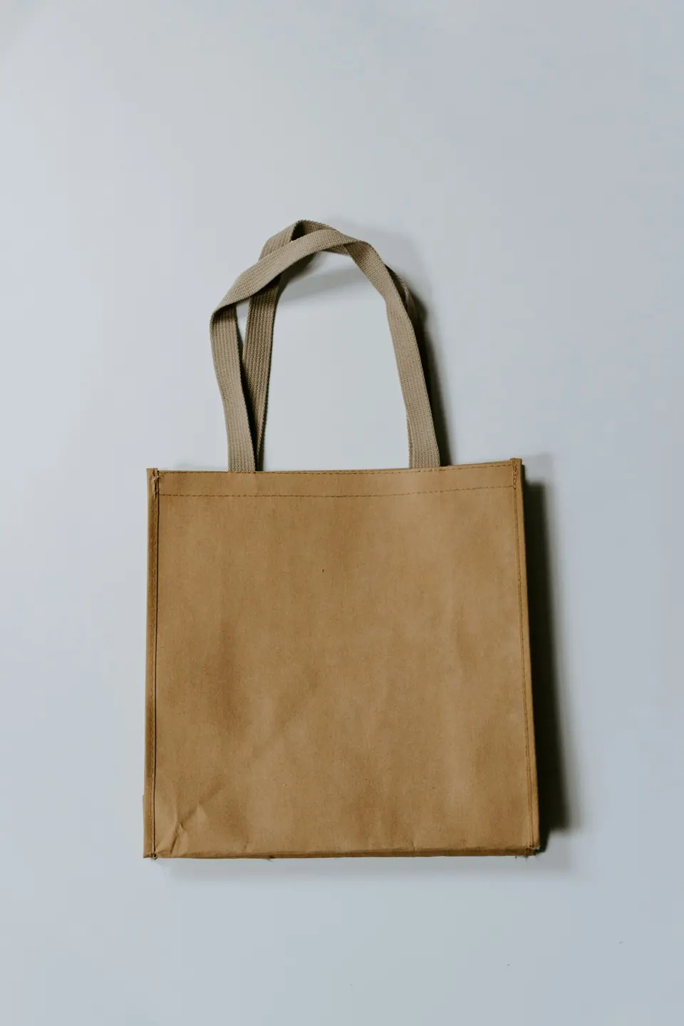 Plain brown tote bag with long handles, ready for printing