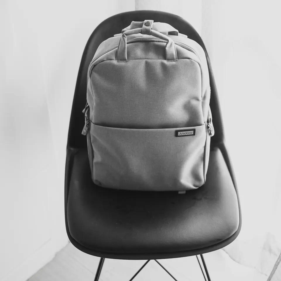 Minimal grey laptop backpack on a chair