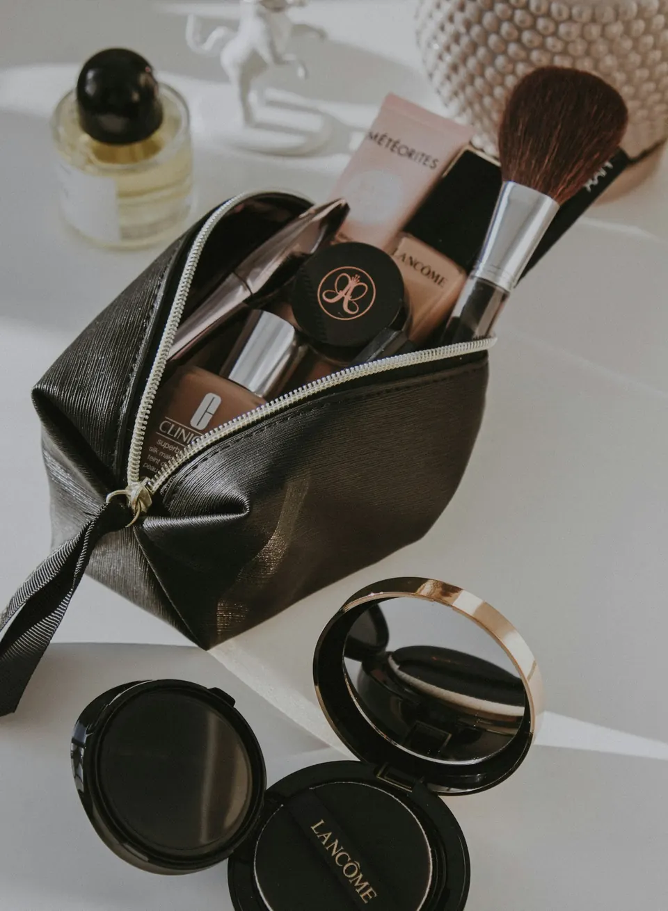 Black leather makeup bag with brushes