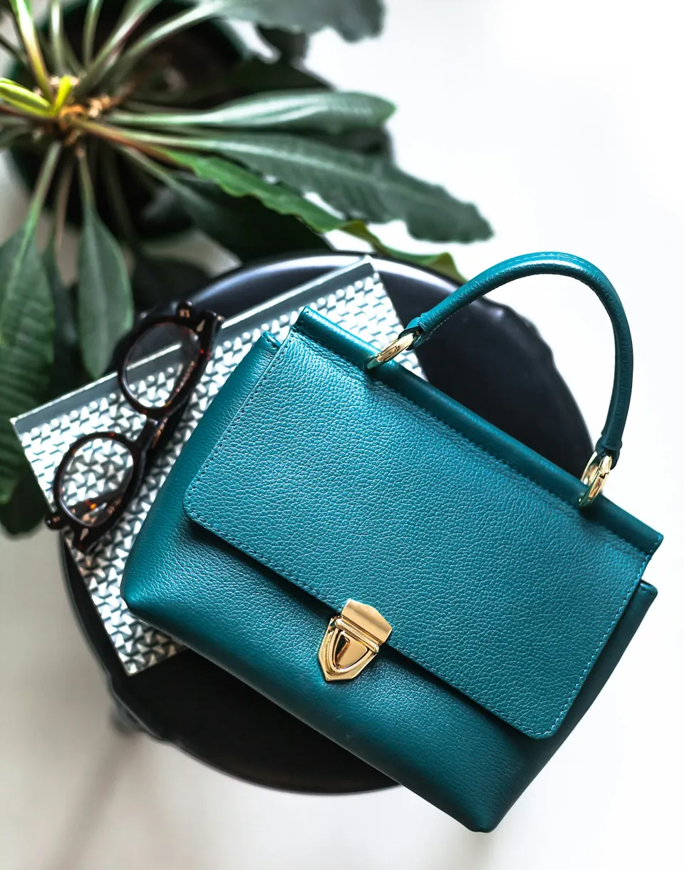 Blue leather handbag on black leather bag