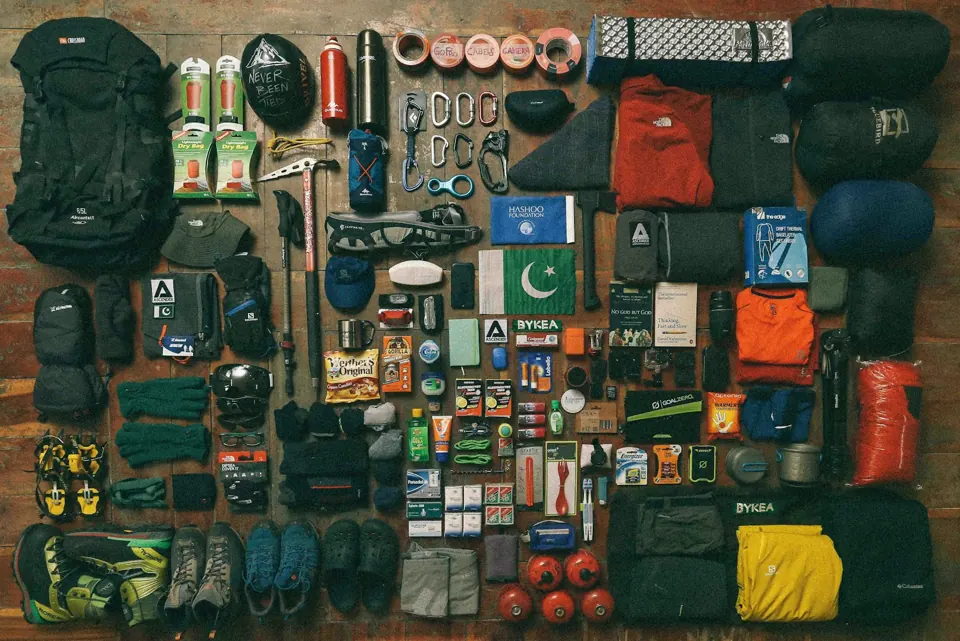 Camping items laid out on black textile