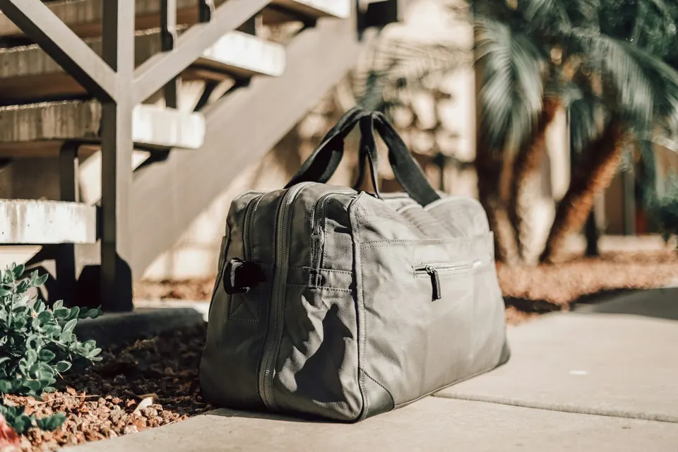 Gray leather backpack on concrete floor