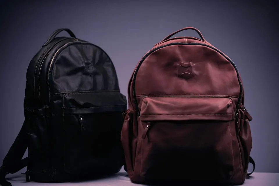 Black and brown backpack on white textile