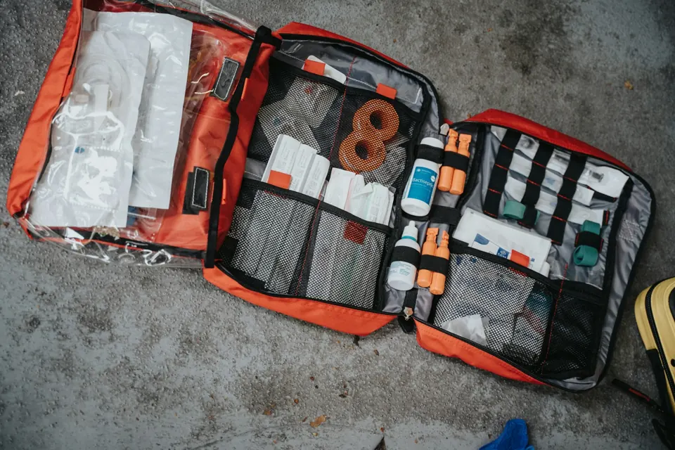 An open red medical bag with supplies