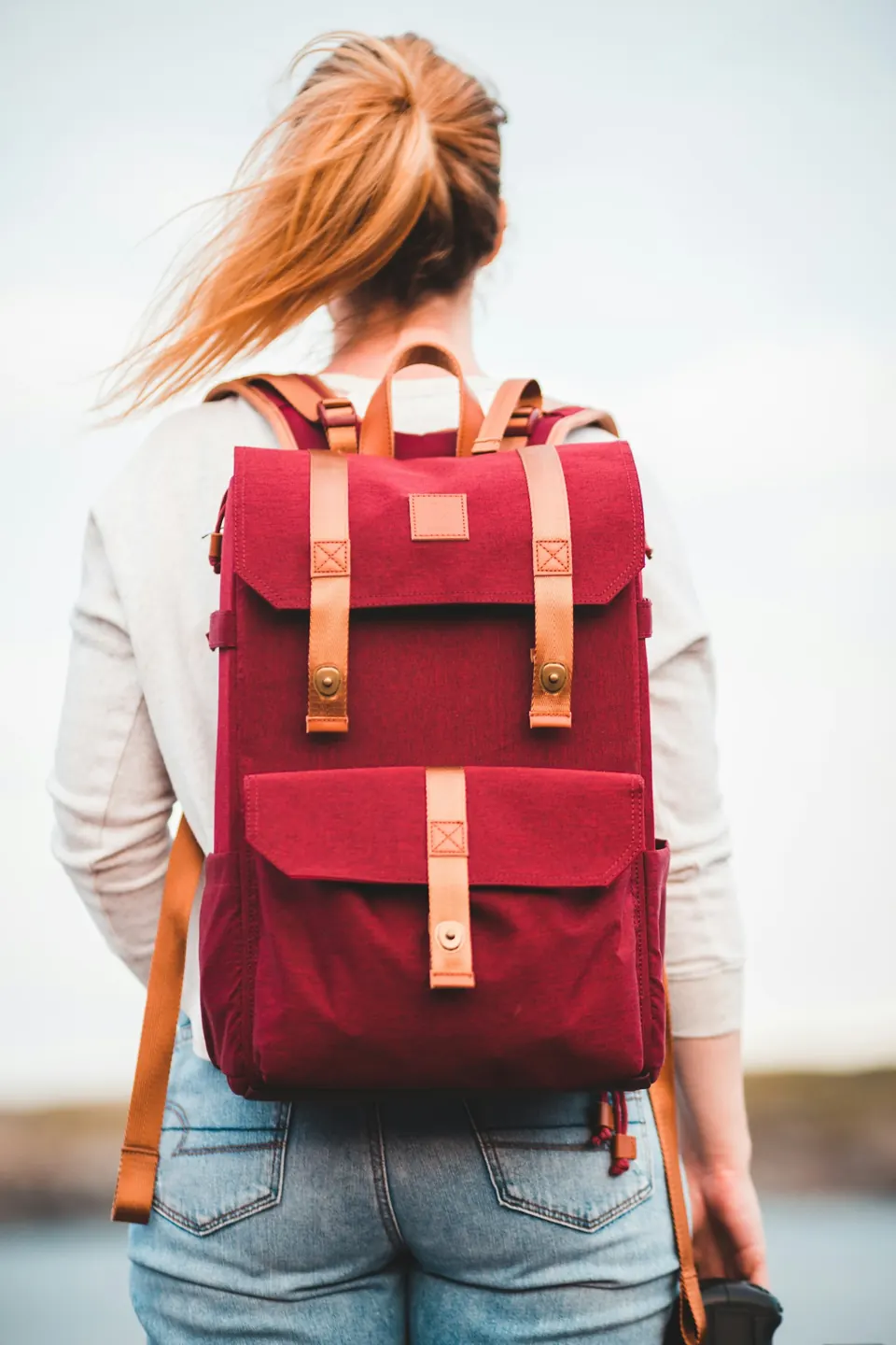 Woman with red and black backpack