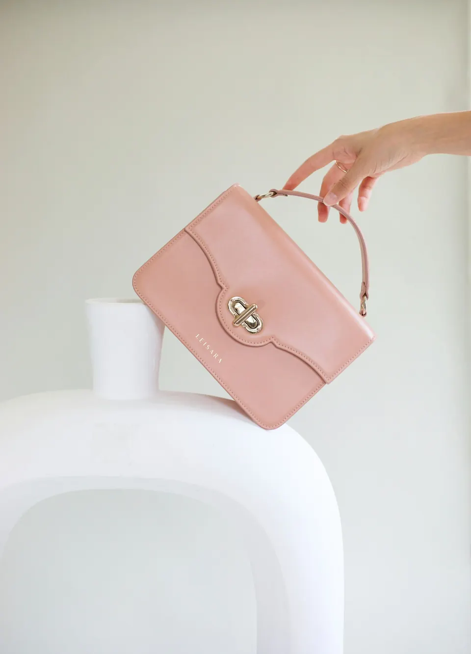 A woman holding a pink purse