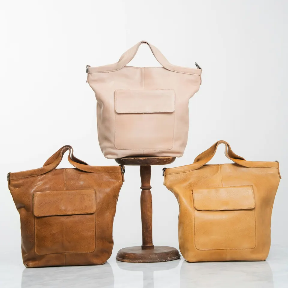 Three leather tote bags in different colours