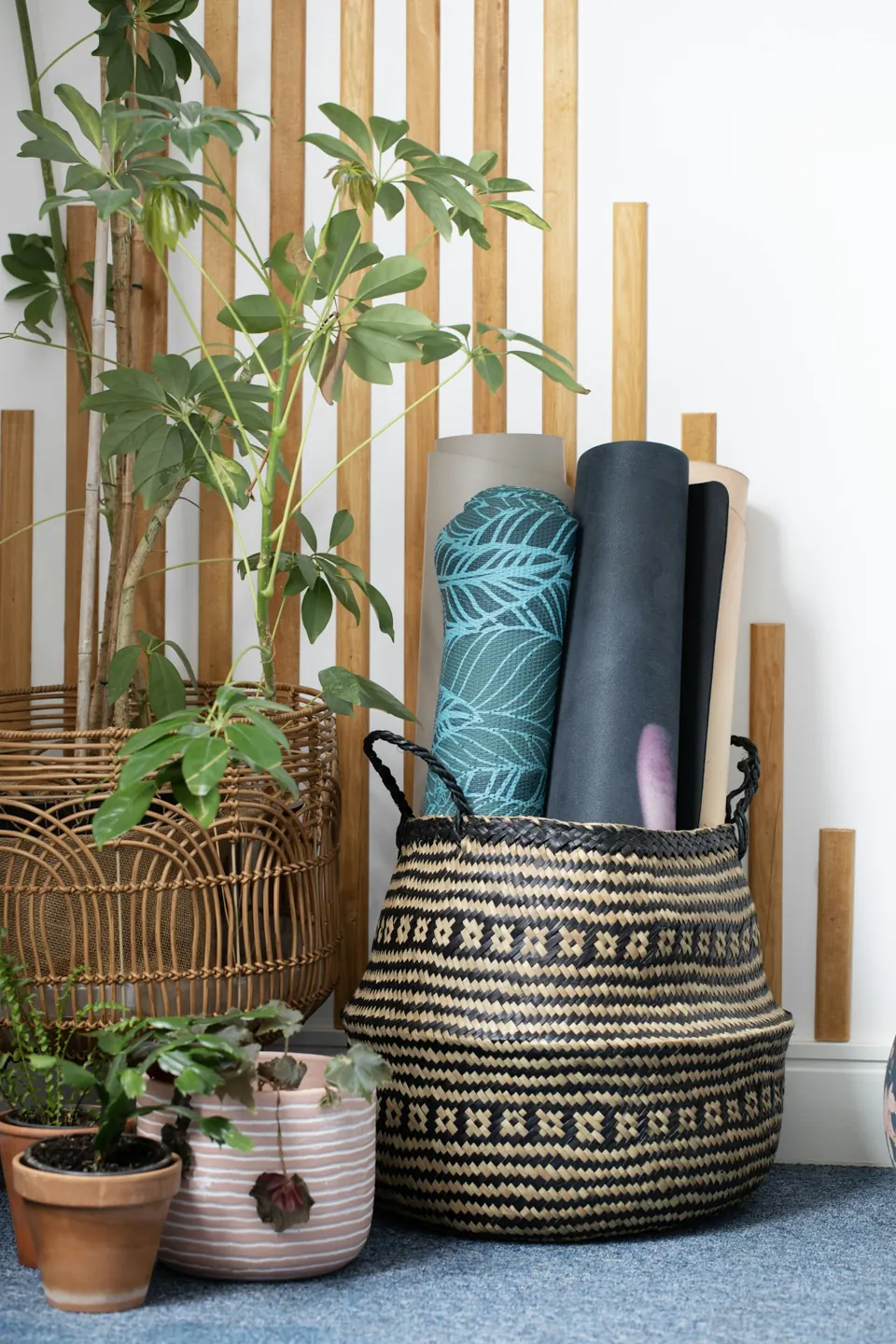 Rolled yoga mats in a basket