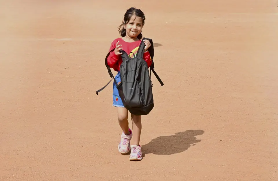 Young girl with backpack walking