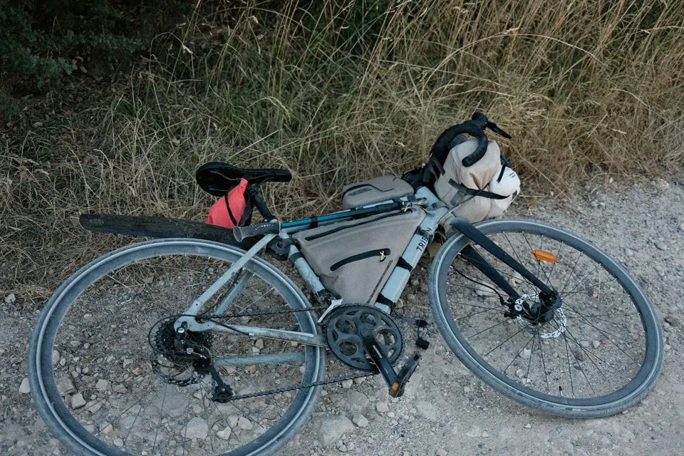 A touring bicycle with bags on a gravel path